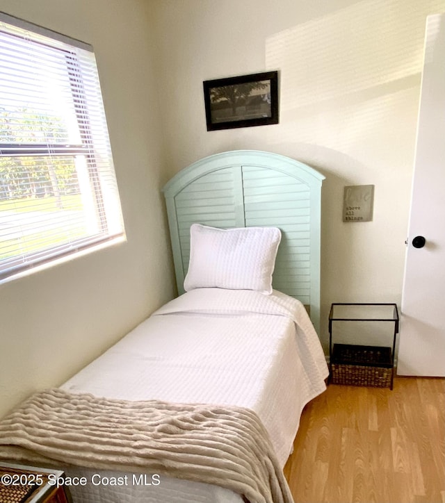 bedroom with wood finished floors