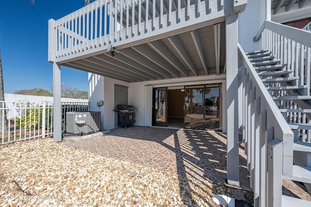 exterior space featuring a patio area, central AC, and fence