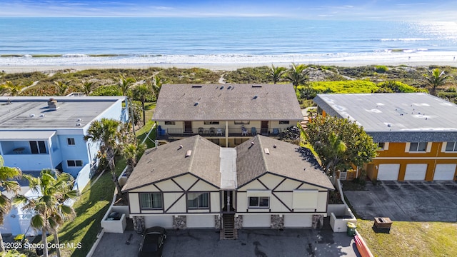 drone / aerial view featuring a beach view and a water view