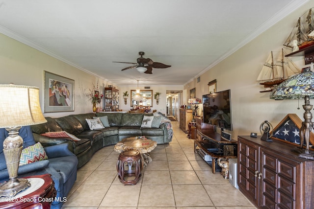 living room with light tile patterned floors, ornamental molding, and a ceiling fan