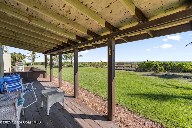 wooden deck with a lawn