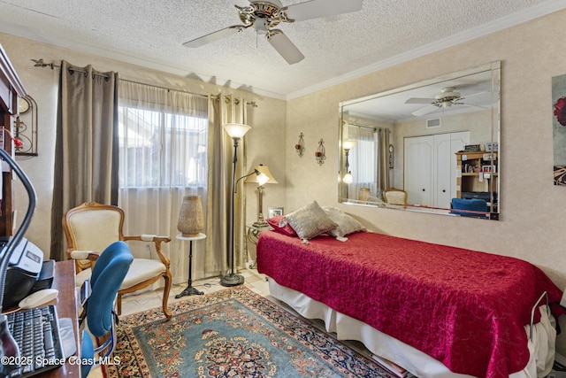 bedroom featuring a textured ceiling, ceiling fan, visible vents, and crown molding