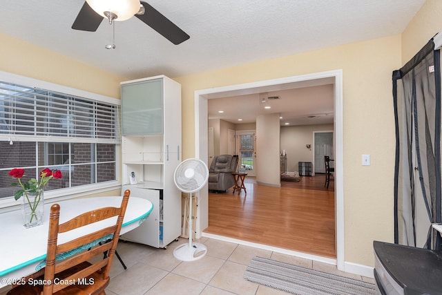 interior space with a ceiling fan and visible vents