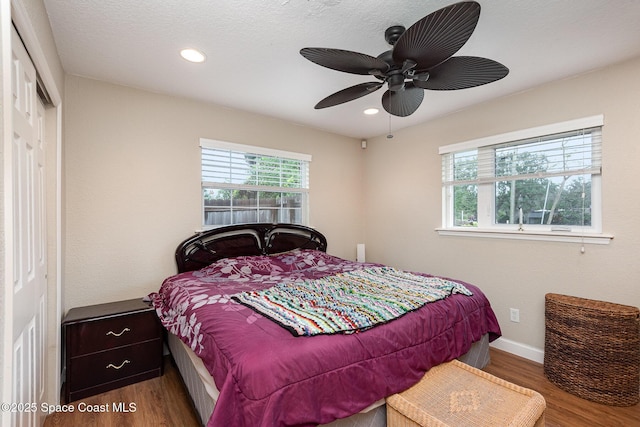 bedroom featuring recessed lighting, a closet, baseboards, and wood finished floors