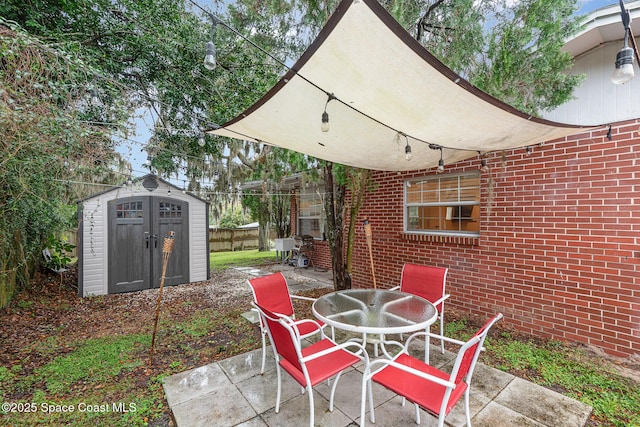 view of patio featuring an outbuilding, a shed, and outdoor dining space