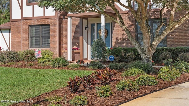 3794 Rambling Acres Dr, Titusville, FL 32796 - doorway to property featuring a yard and brick siding