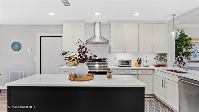 3794 Rambling Acres Dr, Titusville, FL 32796 - kitchen with a center island, visible vents, appliances with stainless steel finishes, a sink, and wall chimney range hood