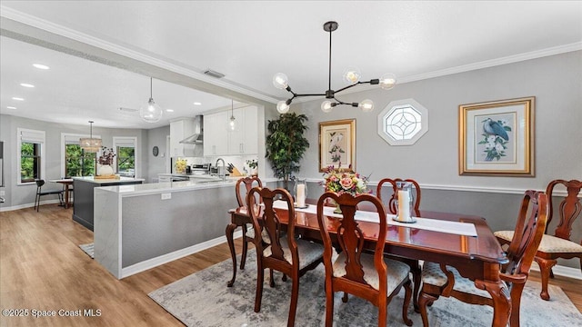 3794 Rambling Acres Dr, Titusville, FL 32796 - dining space featuring recessed lighting, visible vents, baseboards, light wood finished floors, and crown molding