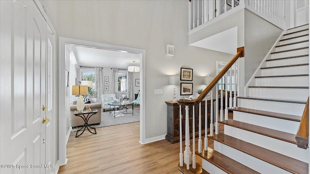 3794 Rambling Acres Dr, Titusville, FL 32796 - entrance foyer with a towering ceiling, stairs, baseboards, and wood finished floors
