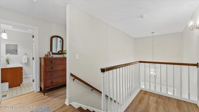 3794 Rambling Acres Dr, Titusville, FL 32796 - staircase featuring a notable chandelier, baseboards, and wood finished floors