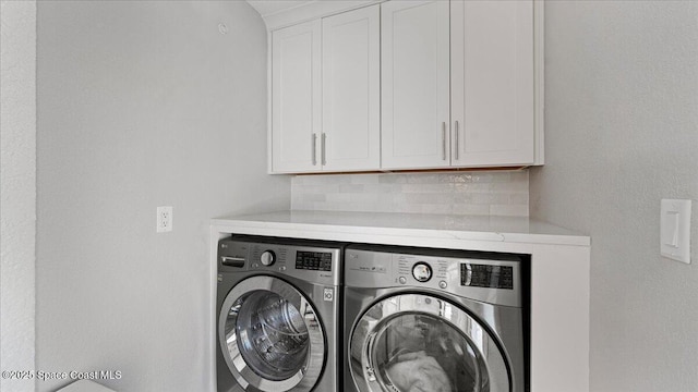 3794 Rambling Acres Dr, Titusville, FL 32796 - clothes washing area featuring washer and clothes dryer and cabinet space