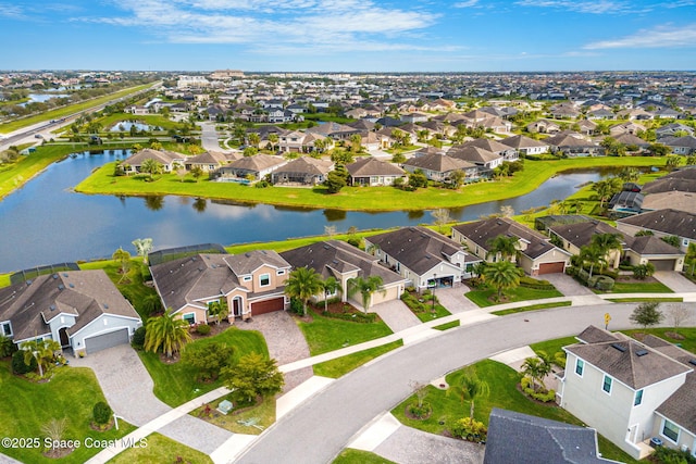 drone / aerial view with a water view and a residential view