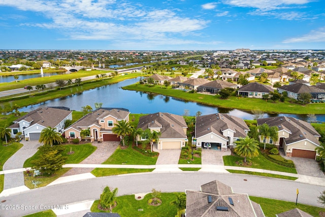 drone / aerial view featuring a water view and a residential view