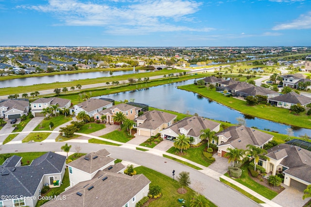 drone / aerial view with a water view and a residential view