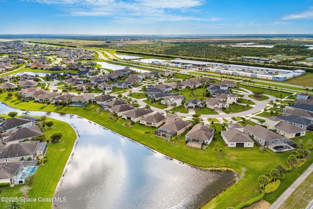 drone / aerial view featuring a residential view and a water view