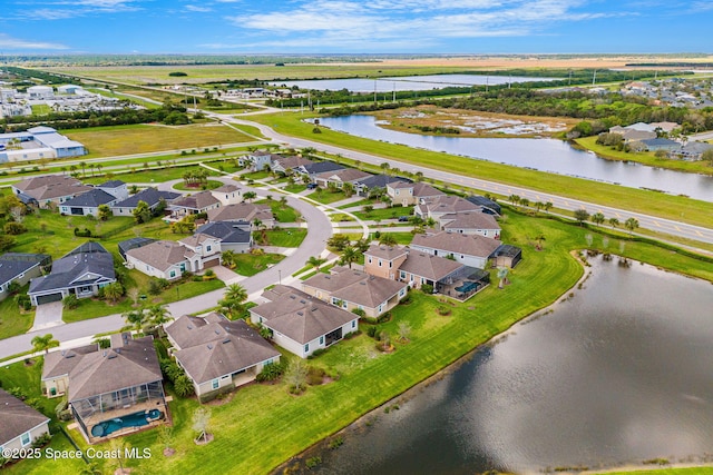 birds eye view of property with a water view and a residential view