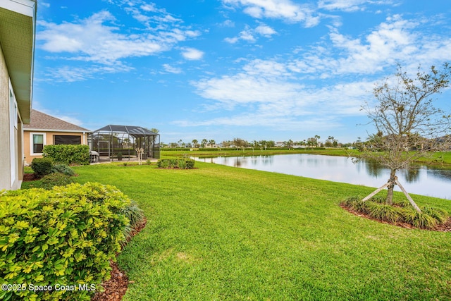 view of yard featuring a water view and glass enclosure