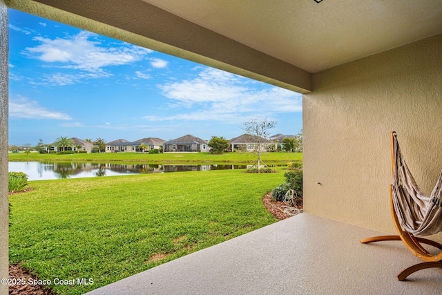 view of yard with a water view and a residential view