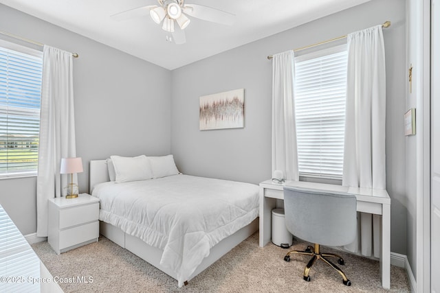 bedroom featuring ceiling fan and baseboards