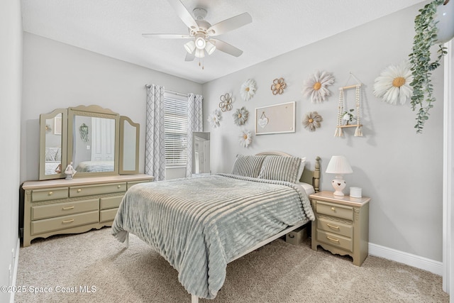 bedroom featuring baseboards, a ceiling fan, and light colored carpet