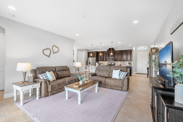 living room with light tile patterned floors, baseboards, and recessed lighting