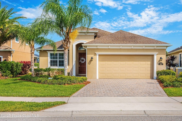 view of front of house with a garage, a shingled roof, decorative driveway, and stucco siding