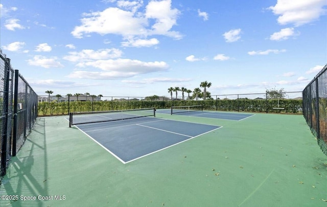 view of tennis court featuring fence