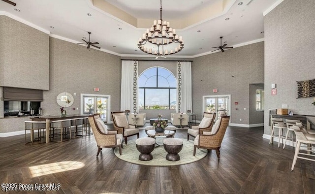 living room featuring hardwood / wood-style flooring, baseboards, a tray ceiling, and french doors