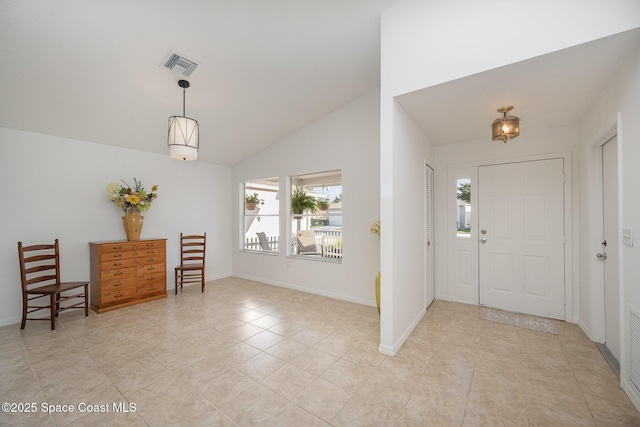 entrance foyer with light tile patterned floors, visible vents, baseboards, and vaulted ceiling