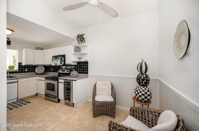 kitchen with stainless steel electric stove, wainscoting, dishwasher, and black microwave