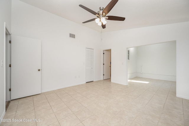 unfurnished bedroom featuring visible vents, high vaulted ceiling, baseboards, and a ceiling fan