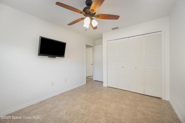 unfurnished bedroom featuring a ceiling fan, baseboards, visible vents, and a closet