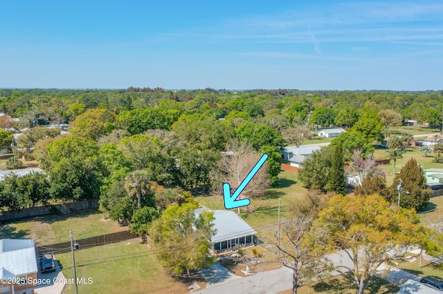 birds eye view of property featuring a view of trees