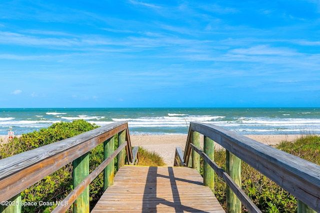 view of home's community with a beach view and a water view