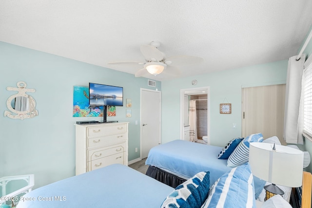 bedroom with ceiling fan, connected bathroom, and visible vents