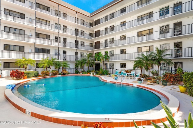 view of swimming pool with fence