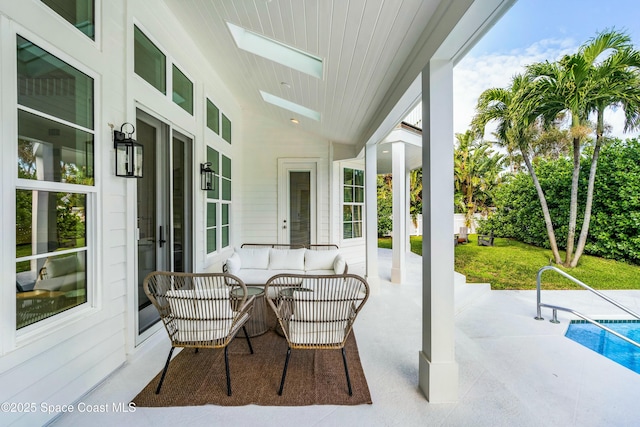 view of patio with outdoor lounge area and an outdoor pool