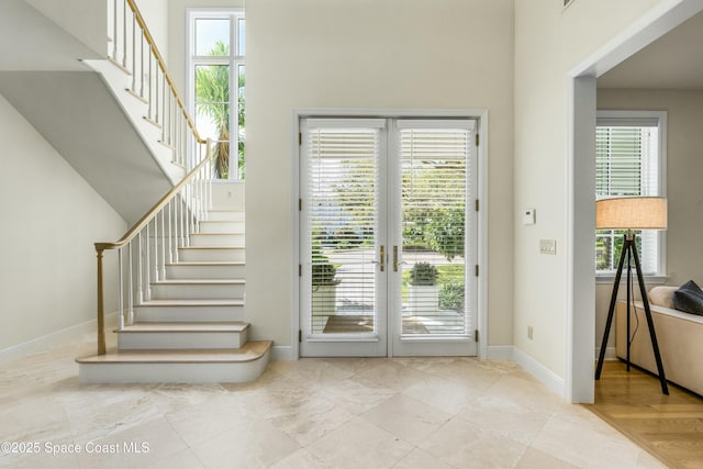 entryway with stairway and baseboards