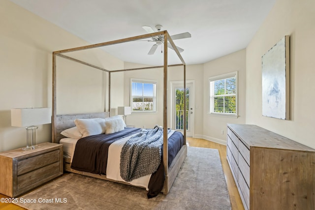 bedroom featuring light wood-style floors, access to outside, ceiling fan, and baseboards