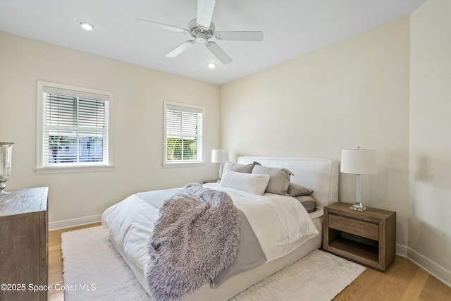 bedroom featuring light wood-style floors, recessed lighting, baseboards, and a ceiling fan