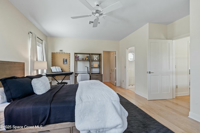 bedroom featuring ceiling fan, wood finished floors, visible vents, and baseboards