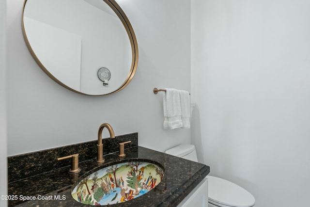 half bathroom featuring toilet and vanity