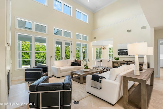 living room with french doors, visible vents, crown molding, and baseboards