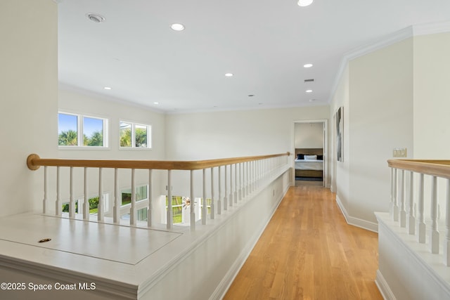 hallway with recessed lighting, baseboards, crown molding, and wood finished floors