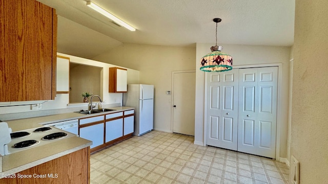 kitchen with white appliances, light countertops, a sink, and light floors