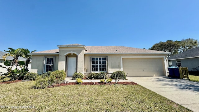 single story home with a front lawn, driveway, an attached garage, and stucco siding