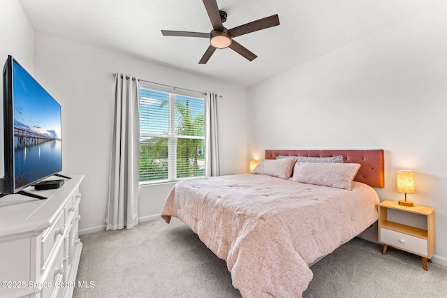 bedroom with light carpet, baseboards, and a ceiling fan