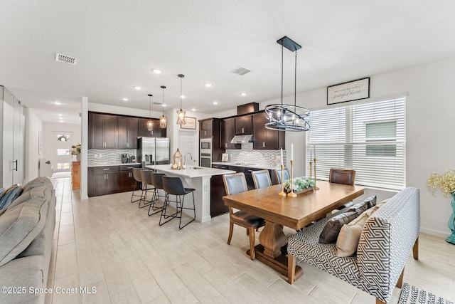 dining space featuring plenty of natural light, visible vents, and recessed lighting