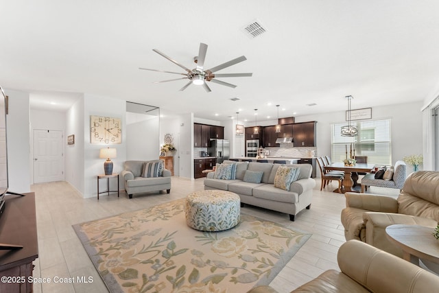 living room featuring light wood-style floors, recessed lighting, visible vents, and ceiling fan