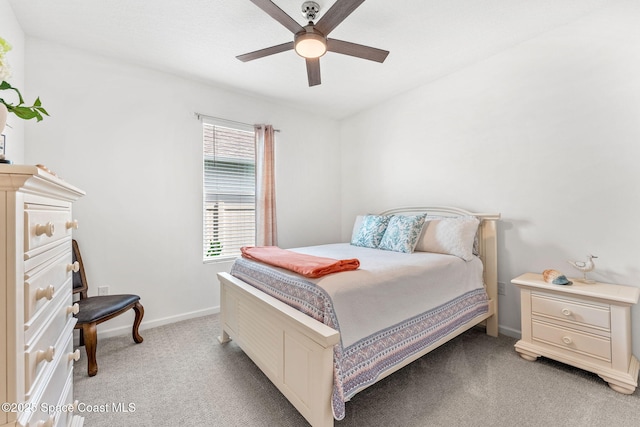 bedroom with baseboards, a ceiling fan, and light colored carpet